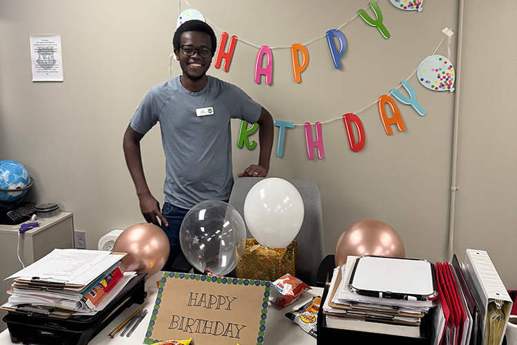 David at his desk with birthday decorations